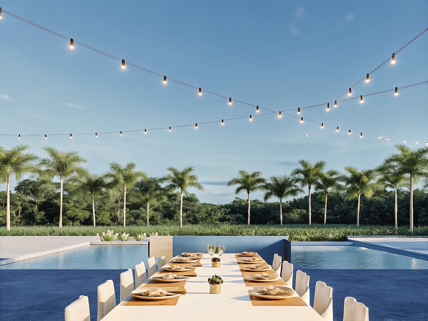 Long outdoor dinner table set for a group at a private villa near Jaco, Costa Rica with string lights and plated food